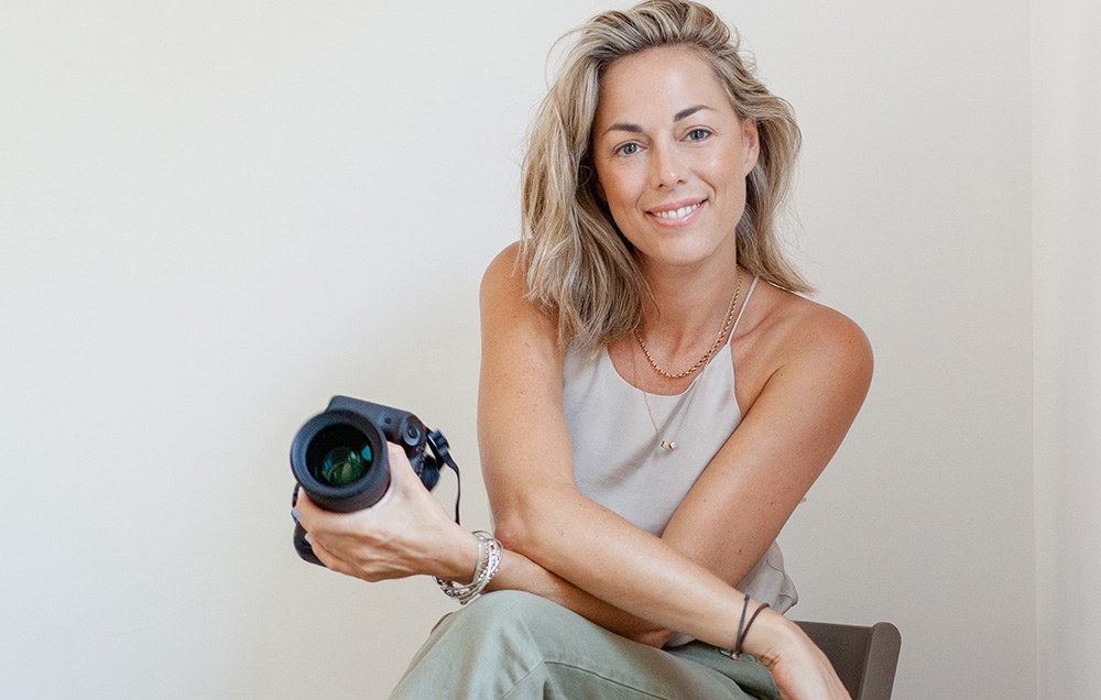 Anette Cook photographer headshot holding a camera